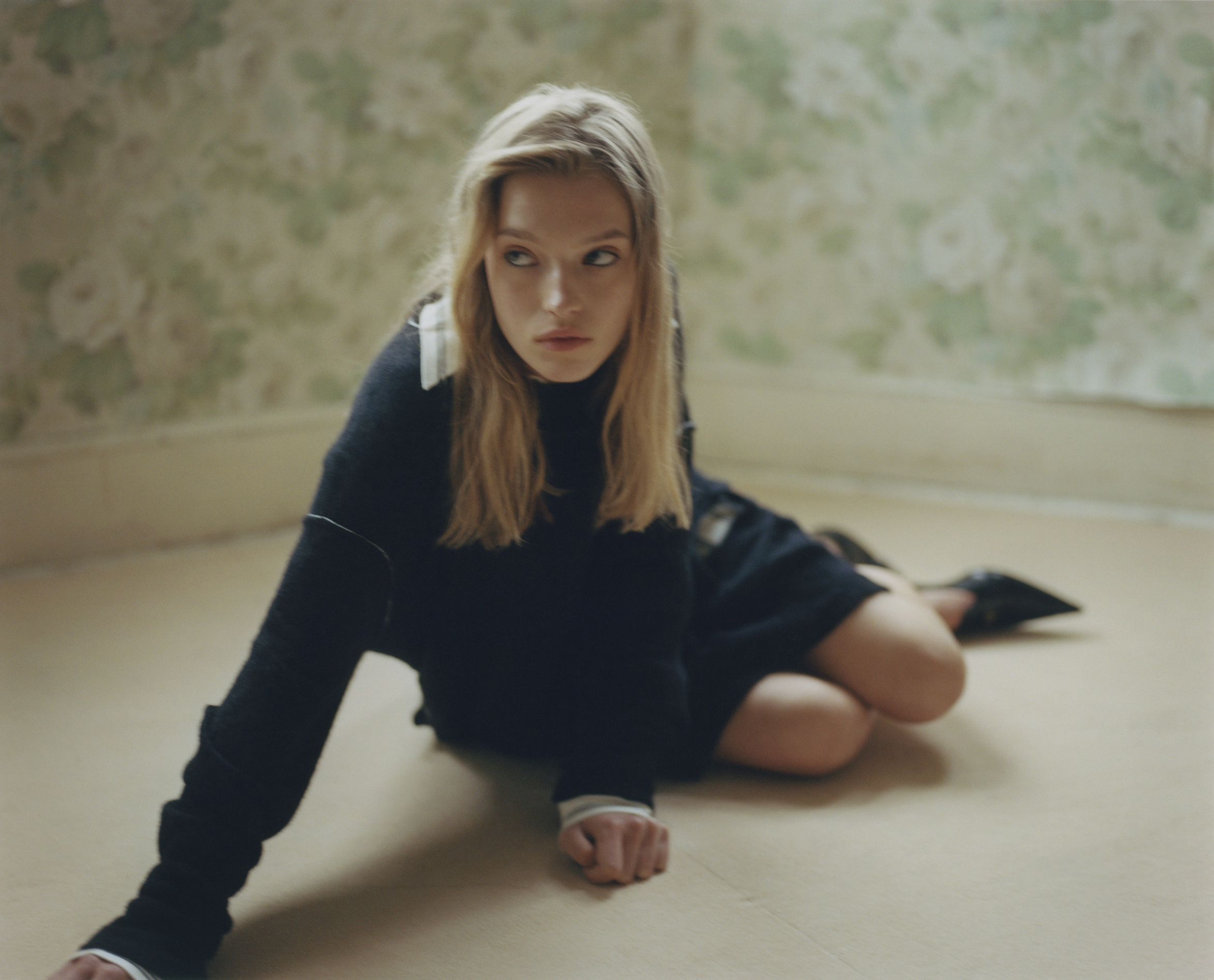 Clemie wears shirt and sweater by MM6, shoes by MIU MIU