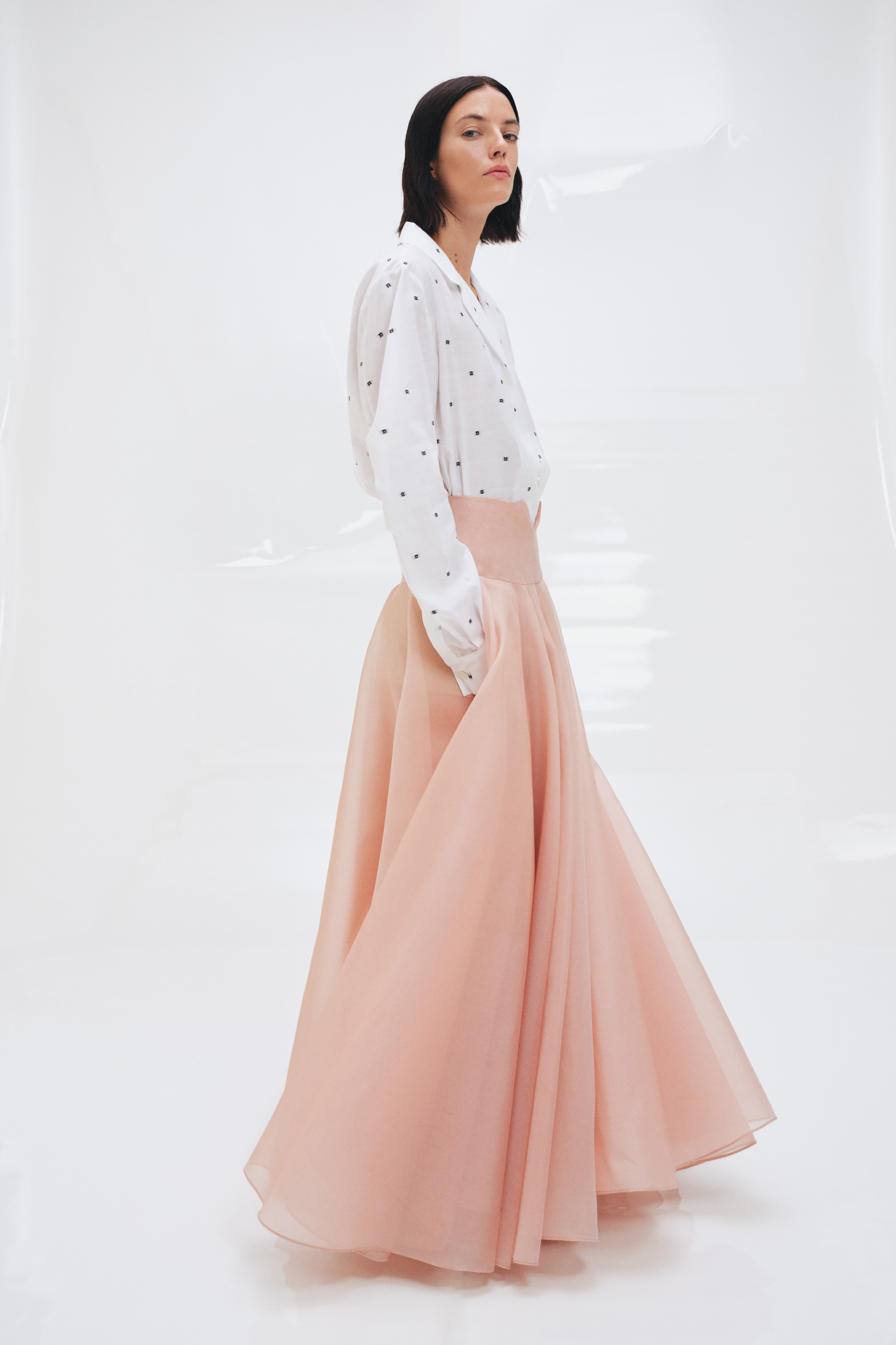 "Subtle Elegance: A Polished Ensemble Merging Classic Polka Dots with a Graceful Pastel Skirt in ROCHAS' Spring-Summer 2024 Collection."
